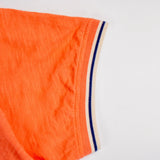 Polo slub orange à col contrasté pour homme BACK to LEGEND (zoom bord de manche)